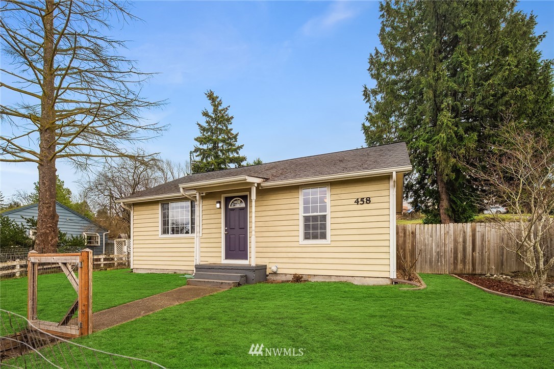 458 Grandey Way Northeast Renton, WA 98056 - Photo 1 of 18 a view of a backyard with plants and a large tree
