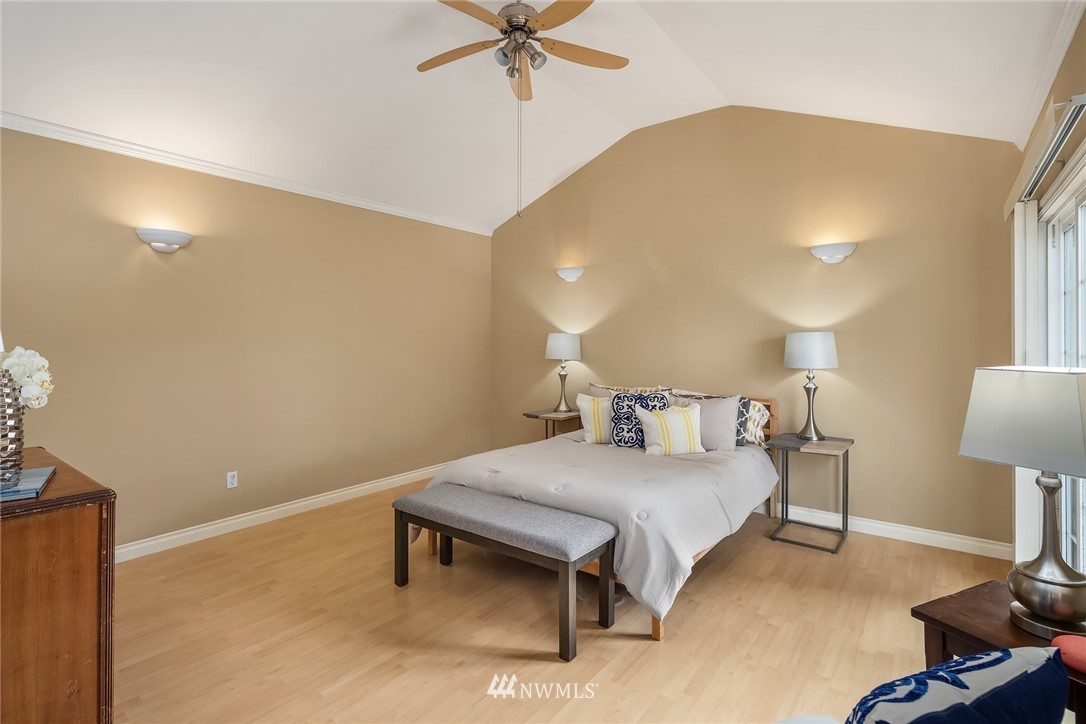 458 Grandey Way Northeast Renton, WA 98056 - Photo 12 of 18 a bedroom with a bed table and a lamp on table