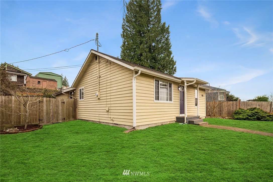 458 Grandey Way Northeast Renton, WA 98056 - Photo 18 of 18 a front view of a house with a garden