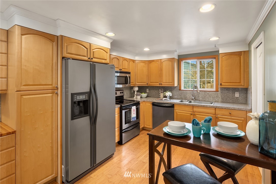 458 Grandey Way Northeast Renton, WA 98056 - Photo 5 of 18 a kitchen with stainless steel appliances granite countertop a refrigerator a stove and a sink