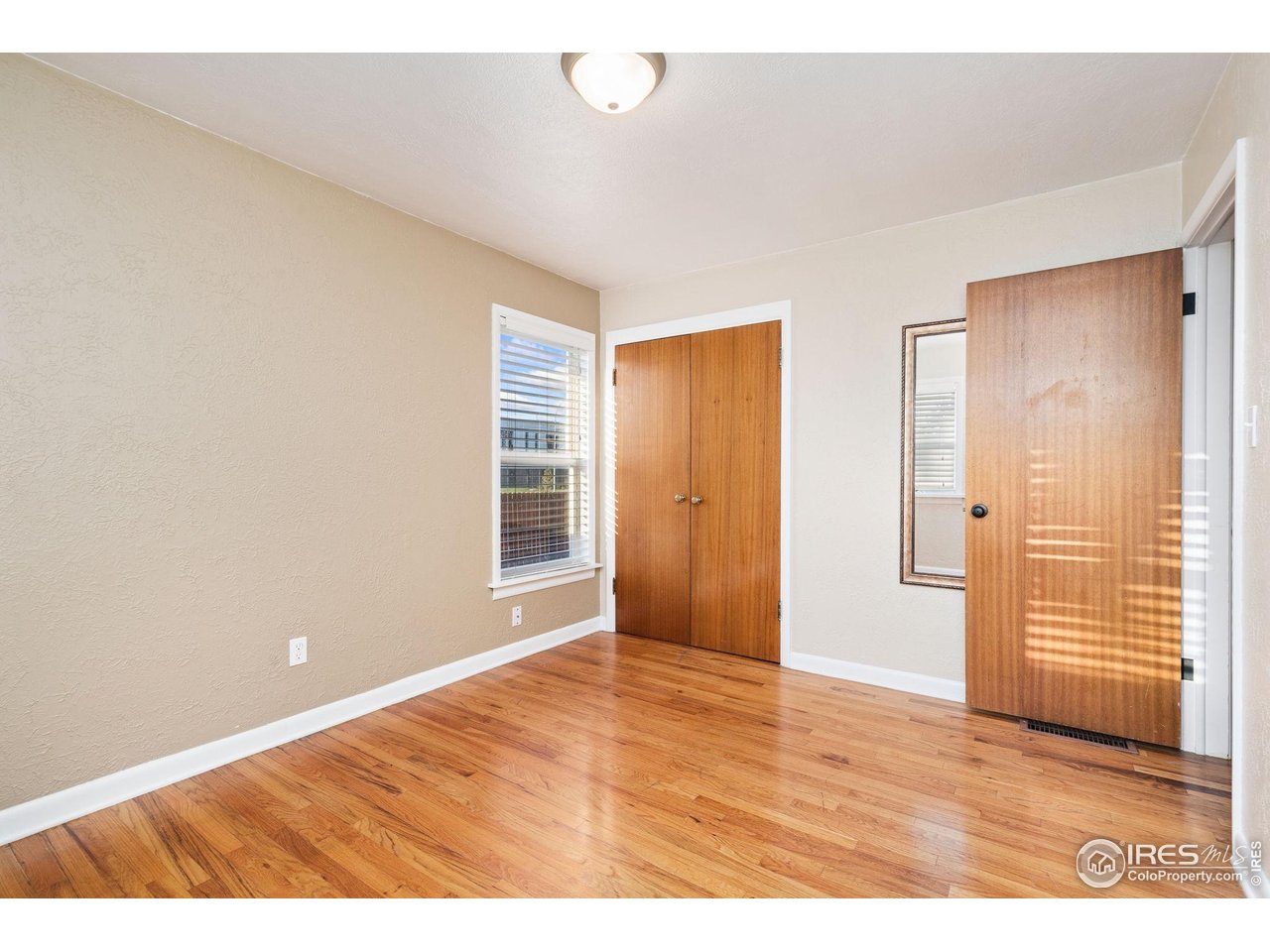 2000 50th Avenue Greeley, CO 80634 - Photo 16 of 34 a view of an empty room with wooden floor and a window