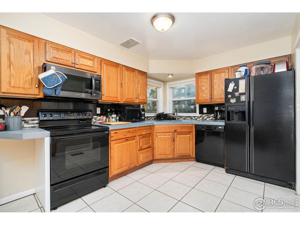 2000 50th Avenue Greeley, CO 80634 - Photo 7 of 34 a kitchen with stainless steel appliances a stove a sink cabinets and a refrigerator