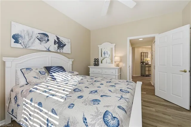 a bedroom with a large bed and a wooden floor