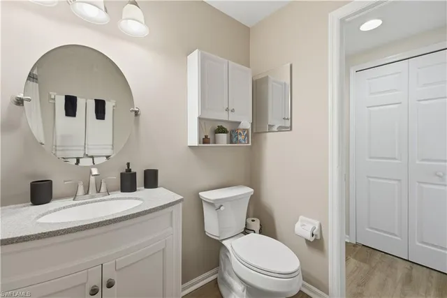 a bathroom with a toilet a sink and mirror