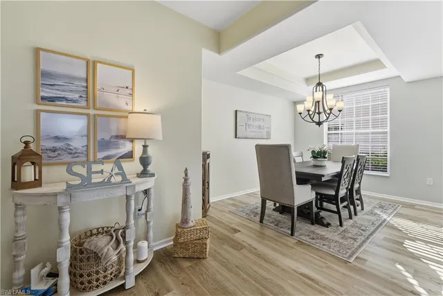 a view of a dining room with furniture and chandelier