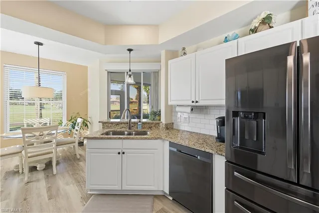 a kitchen with a refrigerator and a sink