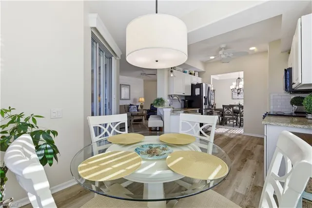 a living room with furniture a dining table and a chandelier