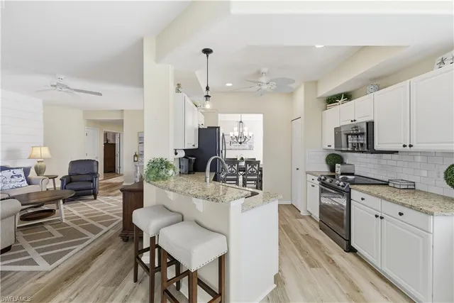 a large white kitchen with cabinets