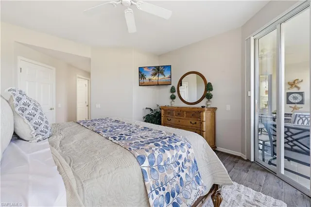 a bedroom with a bed a mirror and a table