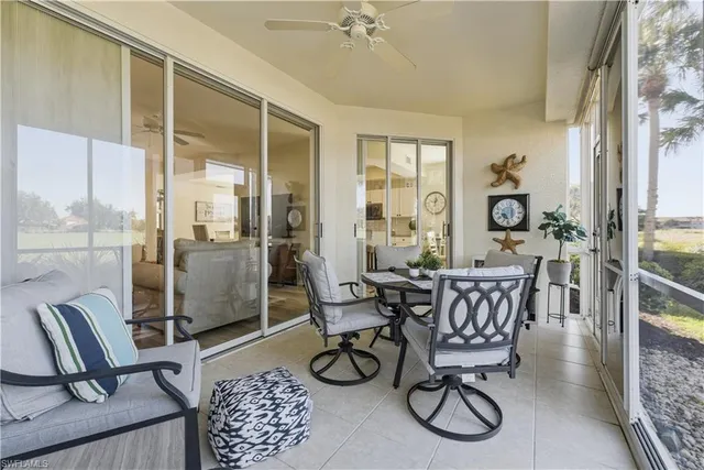 a view of a livingroom with furniture and floor to ceiling window