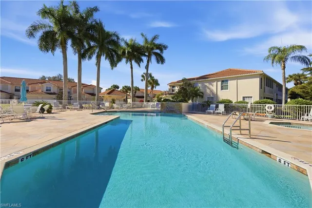 a row of palm trees and swimming pool in the backyard of a house