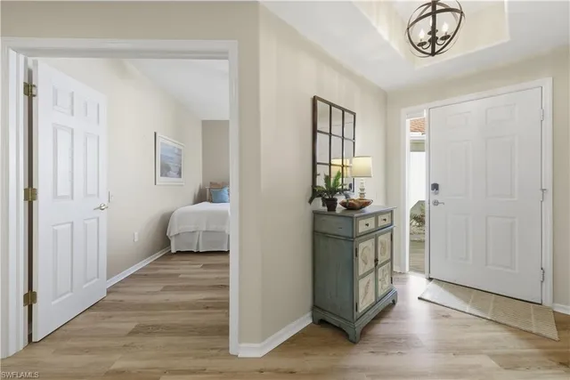 a view of a hallway to a livingroom and a livingroom with furniture a fireplace