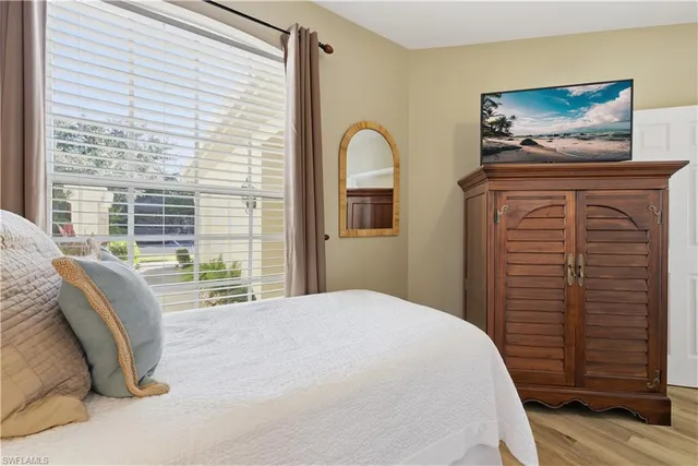 a bedroom with a bed and a painting on the wall
