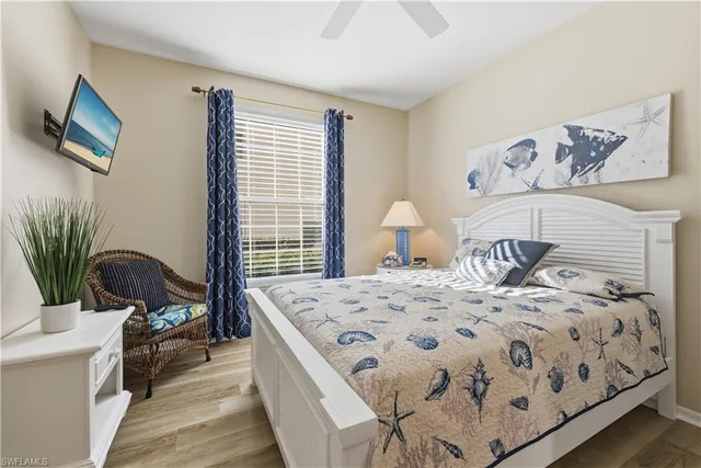 a bedroom with a bed wooden floor and window