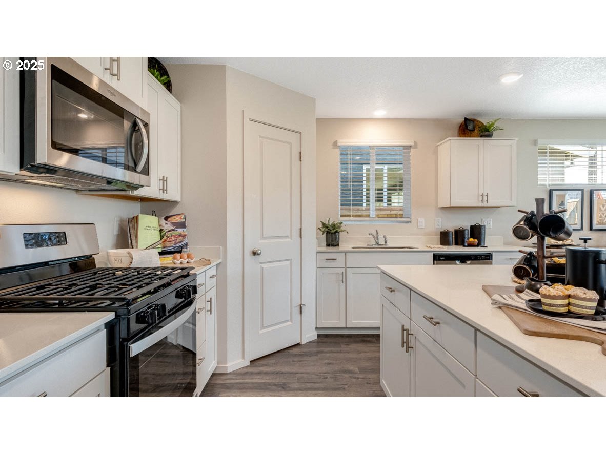 348 Greencrest Street Northeast Salem, OR 97301 - Photo 12 of 26 a kitchen with stainless steel appliances a stove a microwave and cabinets