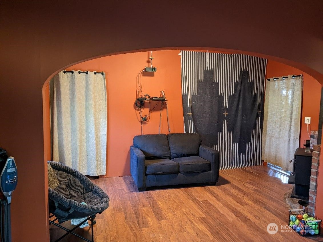 3534 Arnie Road Custer, WA 98240 - Photo 27 of 34 a blue couch sitting in a living room next to a window