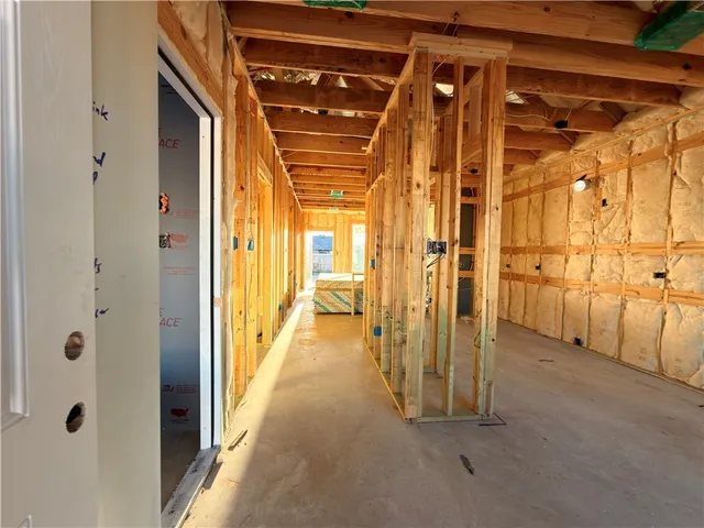 a view of a hallway with wooden shelves