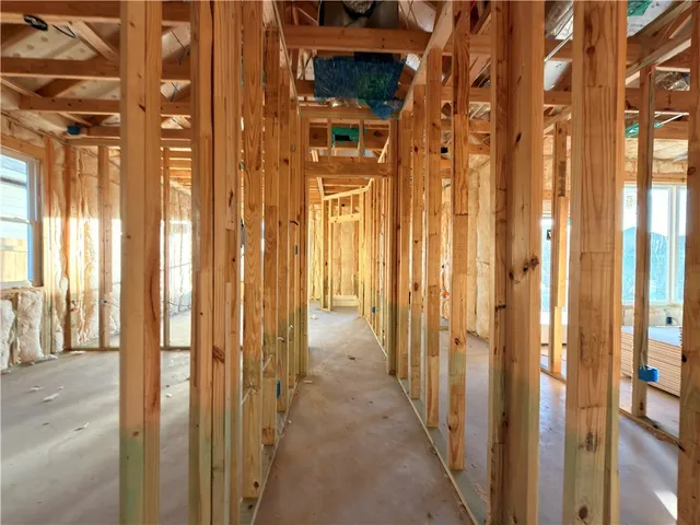 a view of a hallway with a door and windows