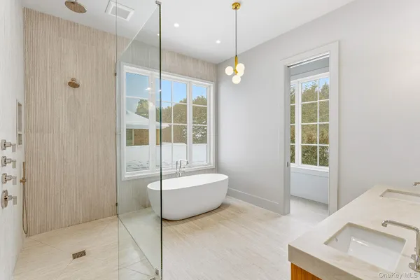 a spacious bathroom with a tub and a shower