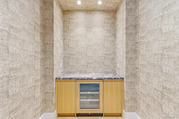 a bathroom with a granite countertop sink and a shower