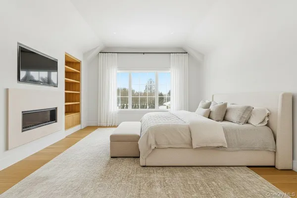 a bedroom with a bed and a fireplace