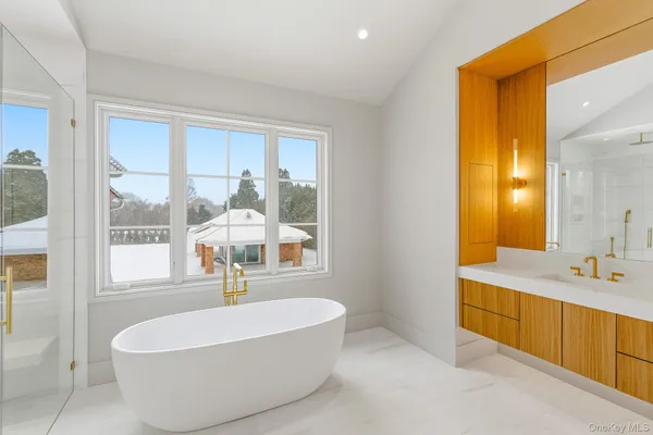 a spacious bathroom with a tub and sink