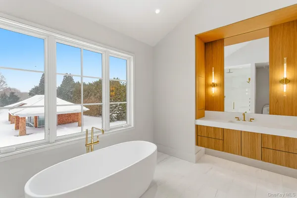 a spacious bathroom with a double vanity sink and a large mirror