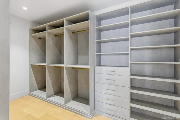 a view of walk in closet with empty racks
