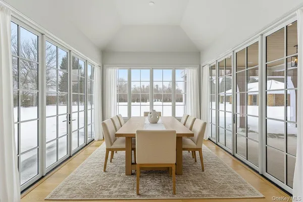 a dining room with furniture wooden floor and a rug