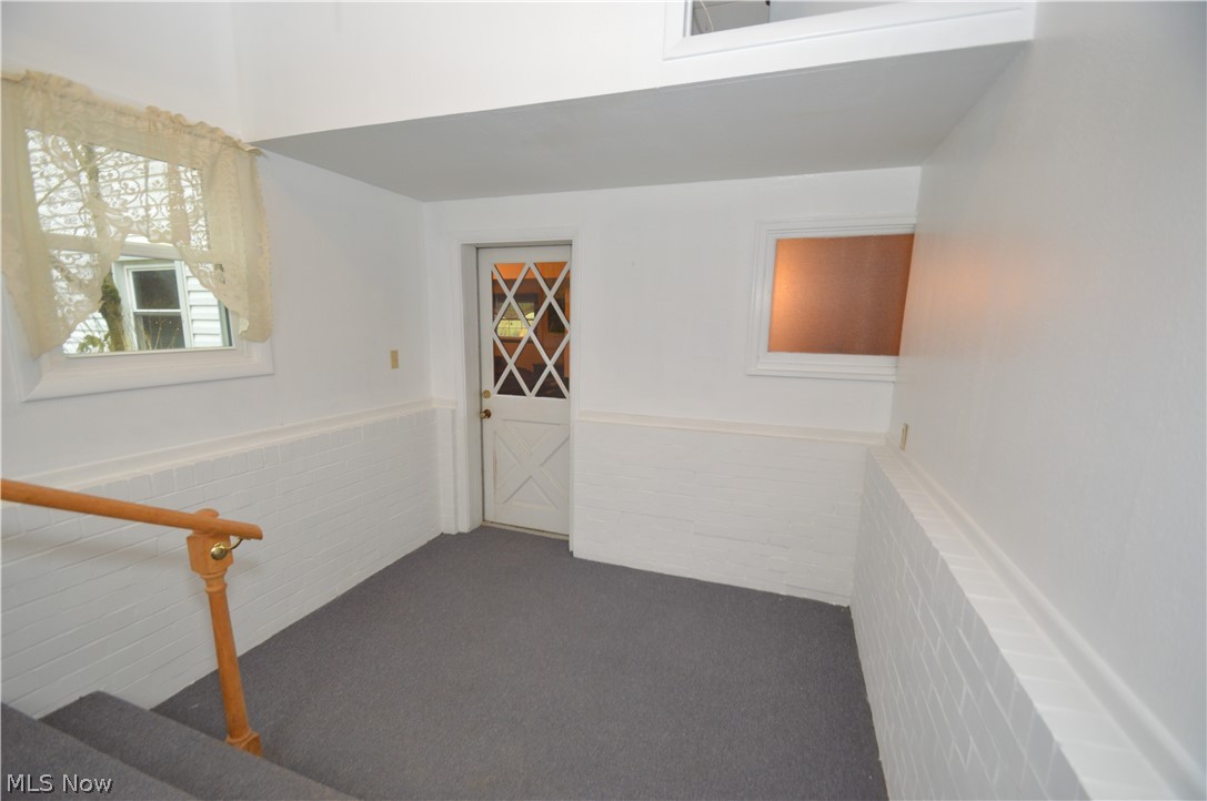 1497 Saxe Road Mogadore, OH 44260 - Photo 22 of 26 Back entry/mudroom leads to the 1st floor family room. Has been freshly painted and includes overhead storage compartment.