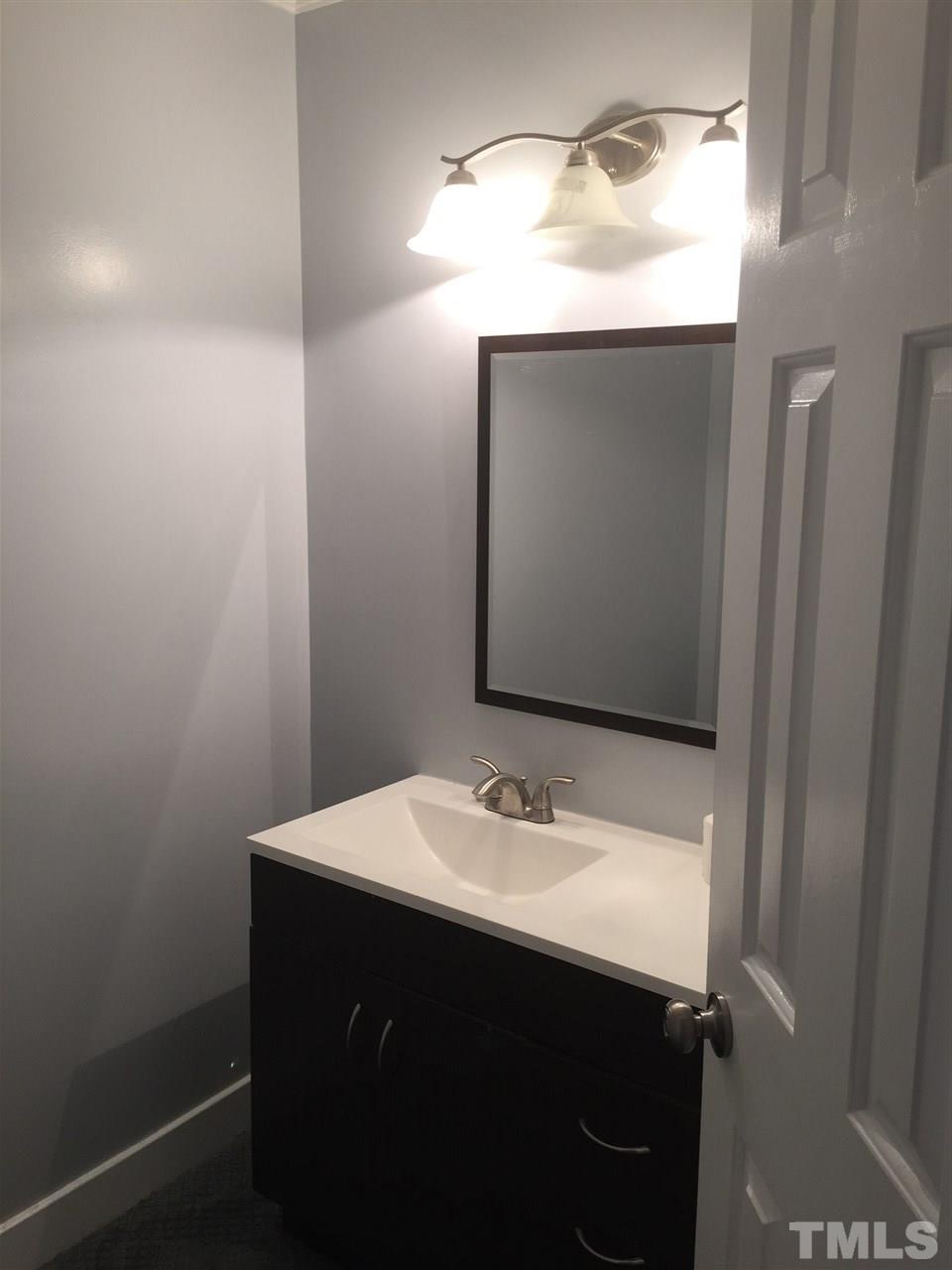 1439 Quarter Point Raleigh, NC 27615 - Photo 14 of 14 a bathroom with a sink vanity and mirror