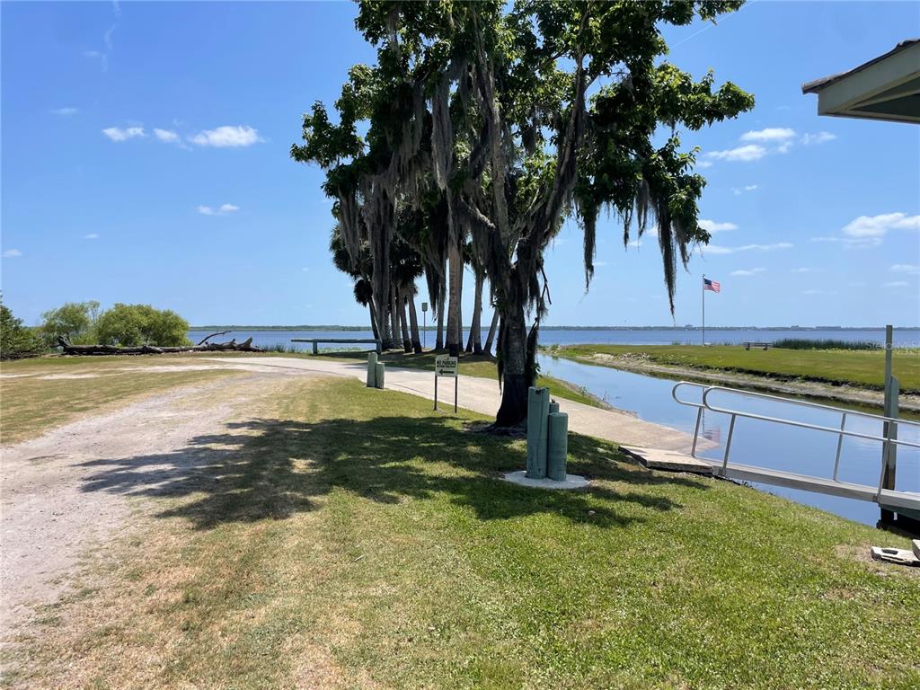 1496 Kettledrum Trail Deltona, FL 32725 - Photo 6 of 11 a view of a lake with a yard and palm trees