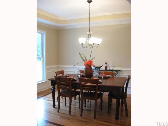 5810 Spring Glen Lane Raleigh, NC 27616 - Photo 3 of 12 a dining room with furniture and wooden floor