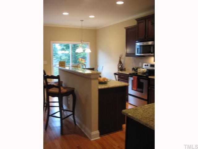 5810 Spring Glen Lane Raleigh, NC 27616 - Photo 5 of 12 a kitchen with stainless steel appliances granite countertop a stove top oven a sink and a refrigerator
