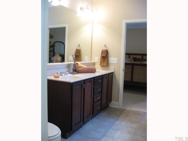 5810 Spring Glen Lane Raleigh, NC 27616 - Photo 10 of 12 a bathroom with a double vanity sink and a mirror