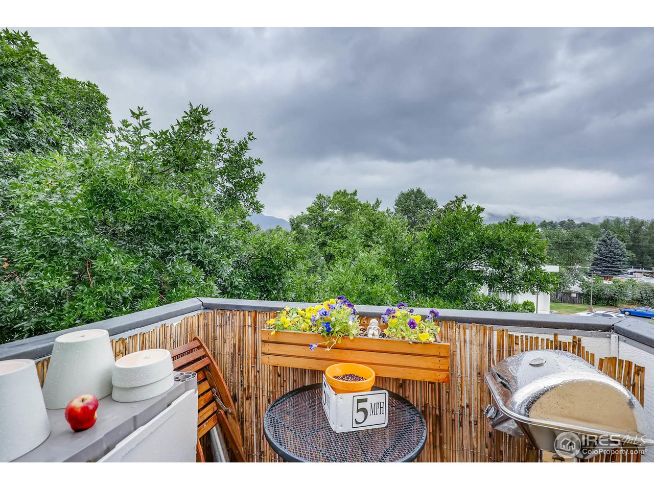 2711 Mapleton Avenue, Unit 27 Boulder, CO 80304 - Photo 1 of 13 a view of a balcony with wooden floor and outdoor seating