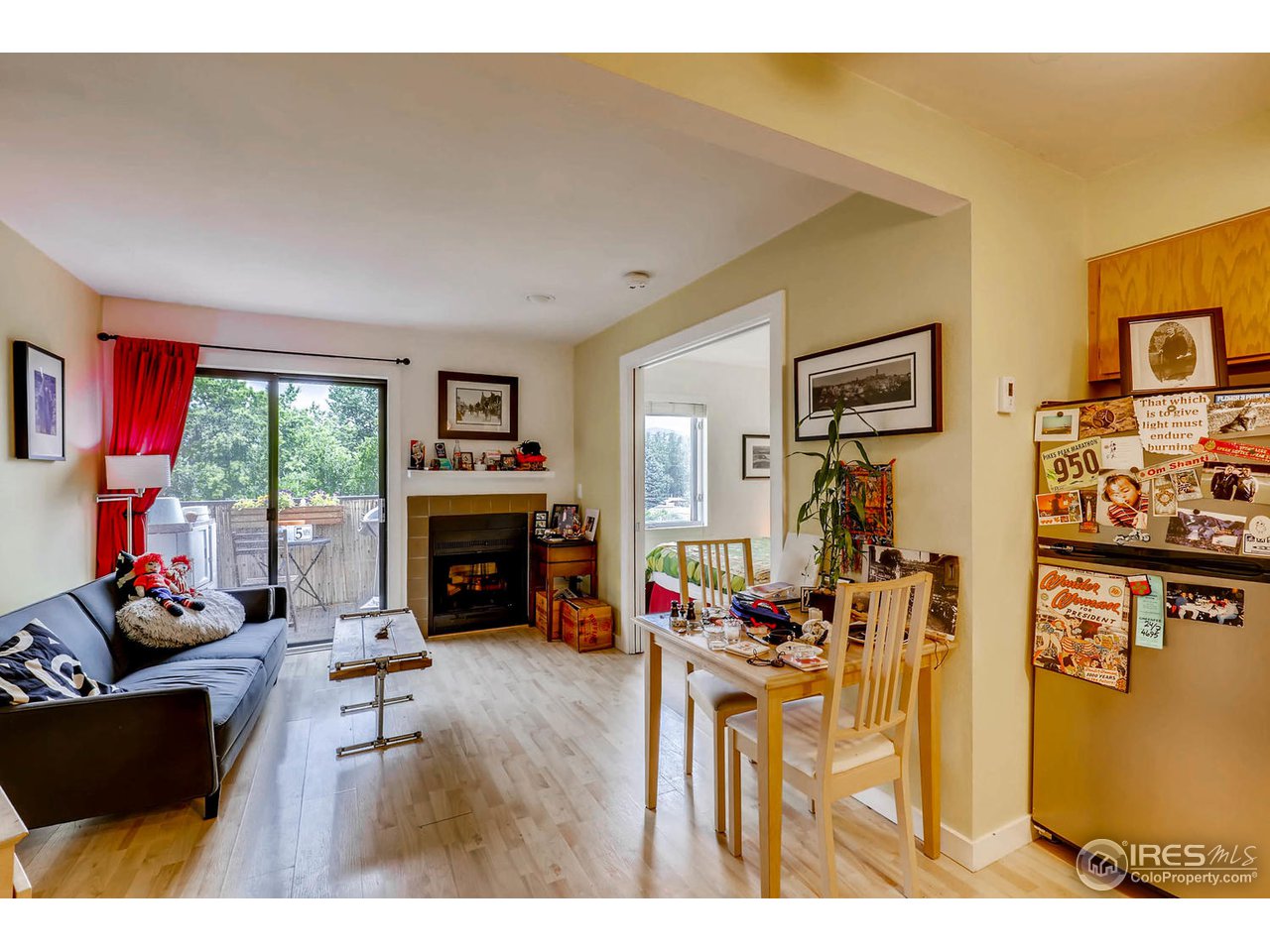 2711 Mapleton Avenue, Unit 27 Boulder, CO 80304 - Photo 7 of 13 a living room with furniture large window and a fireplace