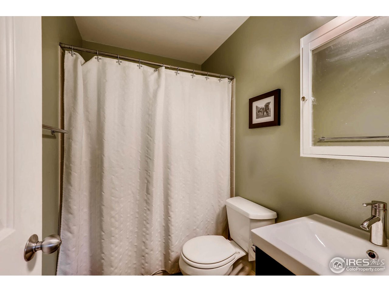 2711 Mapleton Avenue, Unit 27 Boulder, CO 80304 - Photo 10 of 13 a bathroom with a toilet and a shower curtain