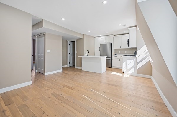 5 Monmouth Street Boston, MA 02128 - Photo 32 of 40 a view of a kitchen with refrigerator and wooden floor