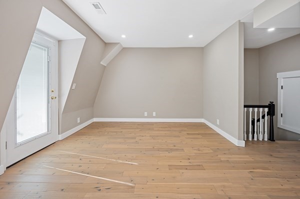 5 Monmouth Street Boston, MA 02128 - Photo 34 of 40 a view of an empty room with wooden floor