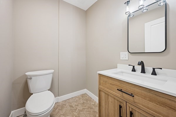 5 Monmouth Street Boston, MA 02128 - Photo 40 of 40 a bathroom with a toilet sink vanity and mirror