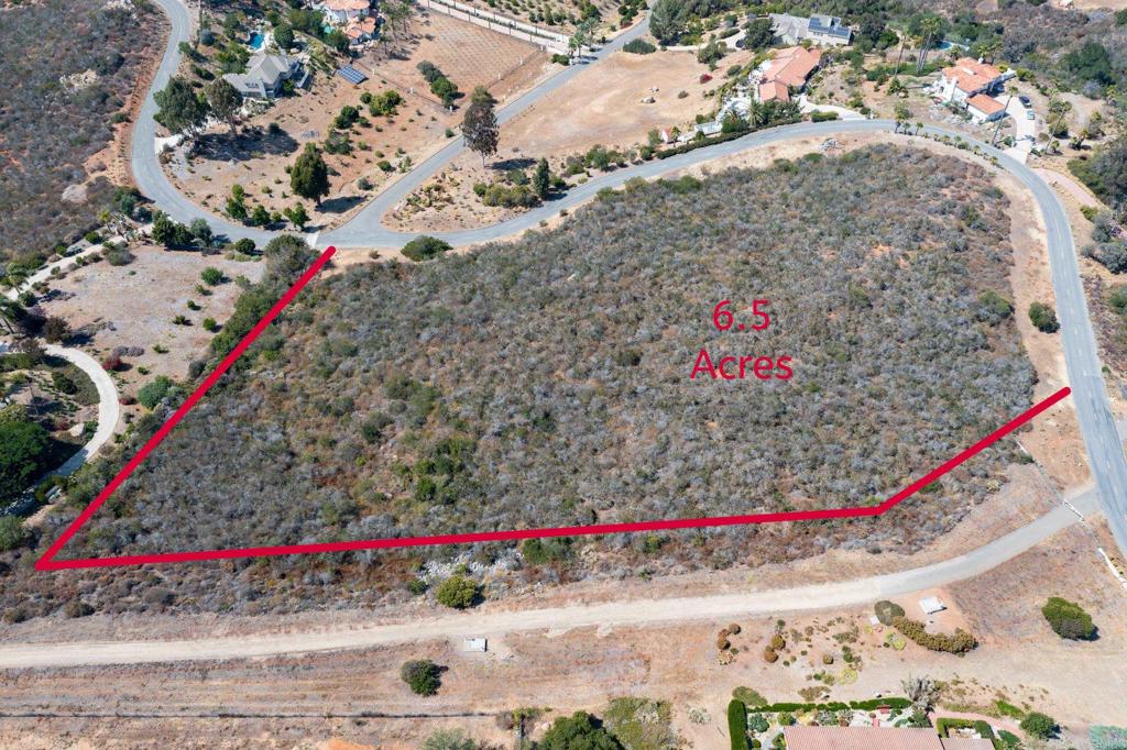 Elevado Rd Vista Vista, CA 92084 - Photo 3 of 11 a view of a white house with a street and a building in the background