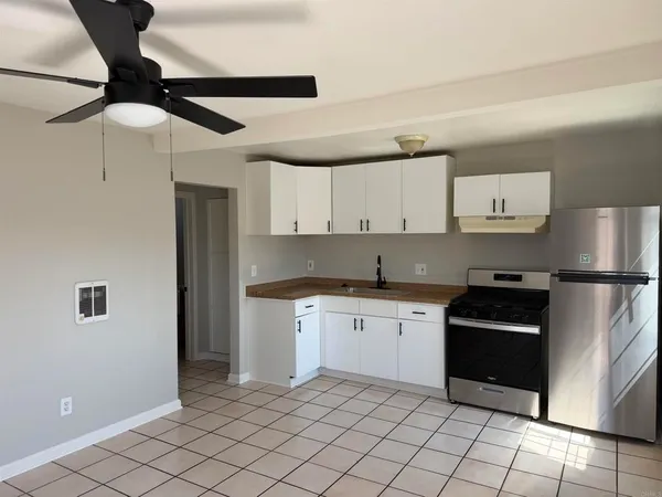 a kitchen with a sink stainless steel appliances and cabinets