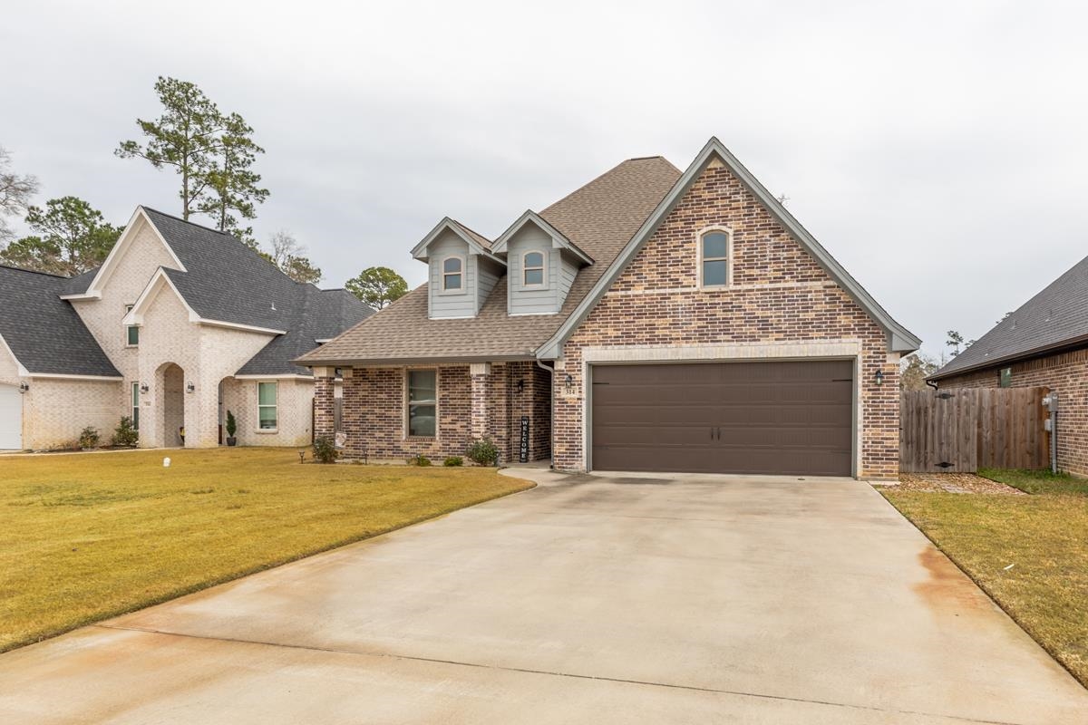 314 Long Leaf Street Silsbee, TX 77656 - Photo 2 of 31 a front view of a house with a yard and garage