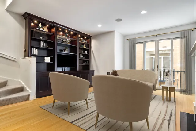 a living room with furniture a lamp and a large window