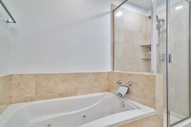 a bathroom with a bathtub and shower
