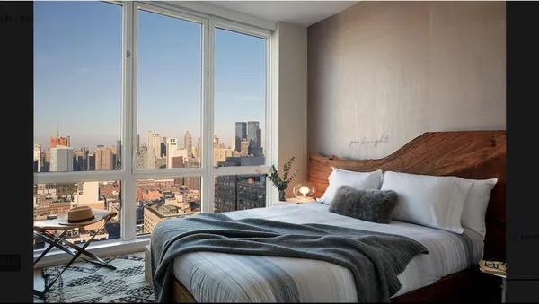 a bedroom with bed and balcony view