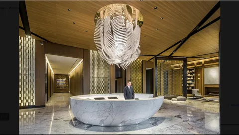 a lobby with furniture and a large mirror