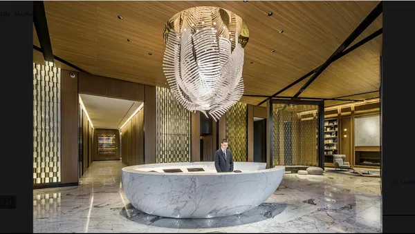 a lobby with furniture and a large mirror