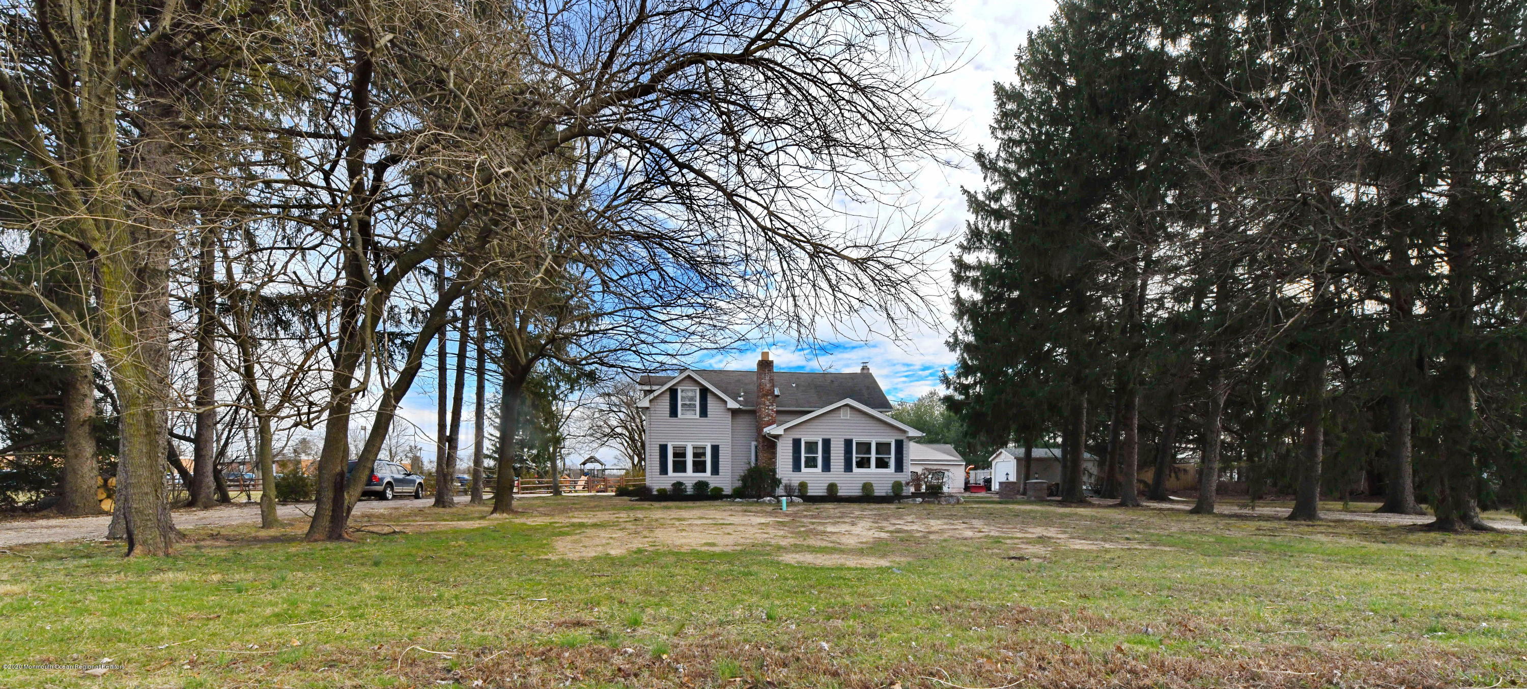 1871 Lanes Mill Road Brick, NJ 08724 - Photo 2 of 31 a front view of a house with a garden and trees